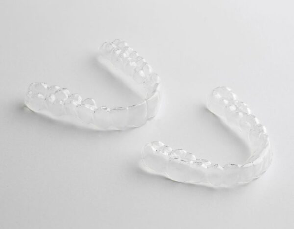 Two retainers on a white table facing the same direction