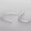 Two clear retainers on a white table